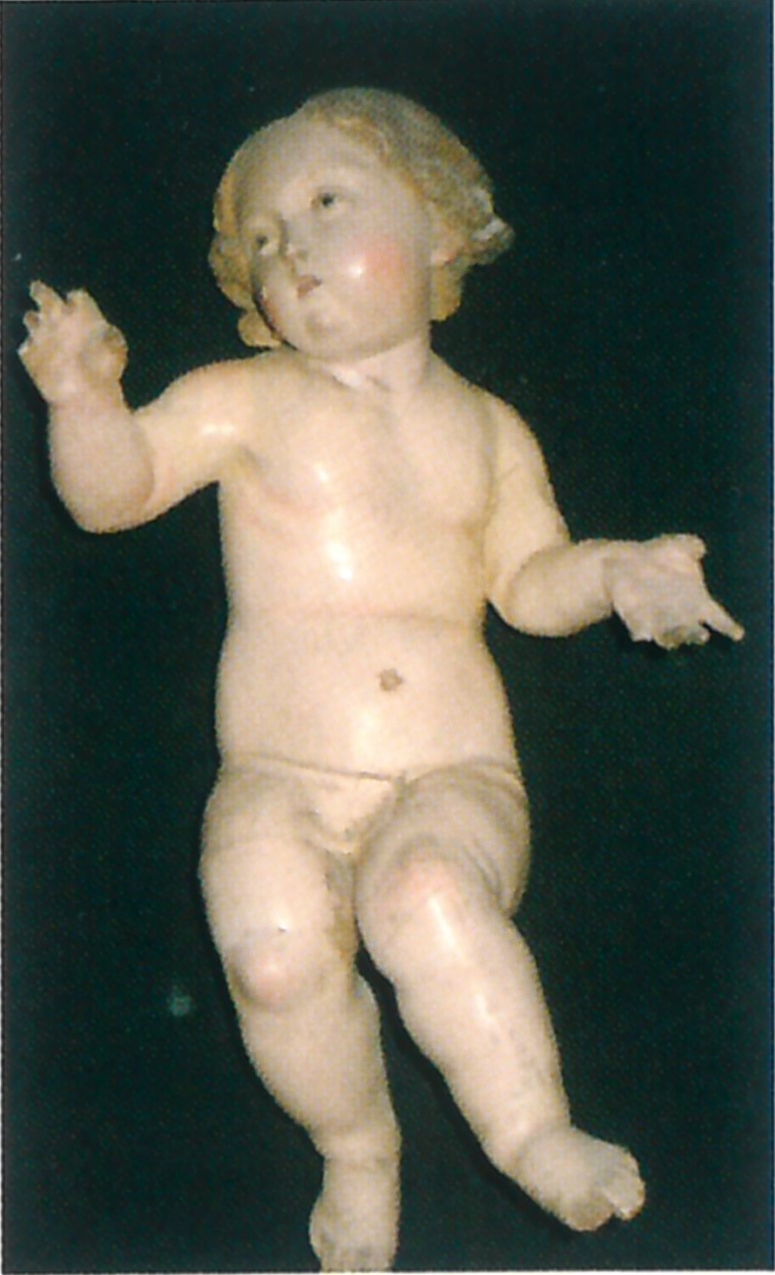 Fig. 11 - PIRRI, Chiesa di S.Pietro, San Giuseppe, particolare del Bambin Gesù, scultura lignea con policromia, bottega napoletana, sec. XIX.
